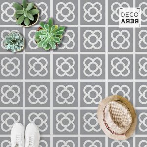 A stylish gray tile floor with decorative Barcelona's Panot flower patterns and potted succulents